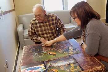 man and woman doing a puzzle